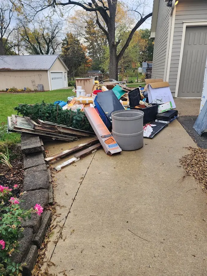 Dumpster being loaded with debris for Estate Cleanout Dumpster Rental in Fair Oaks Ranch